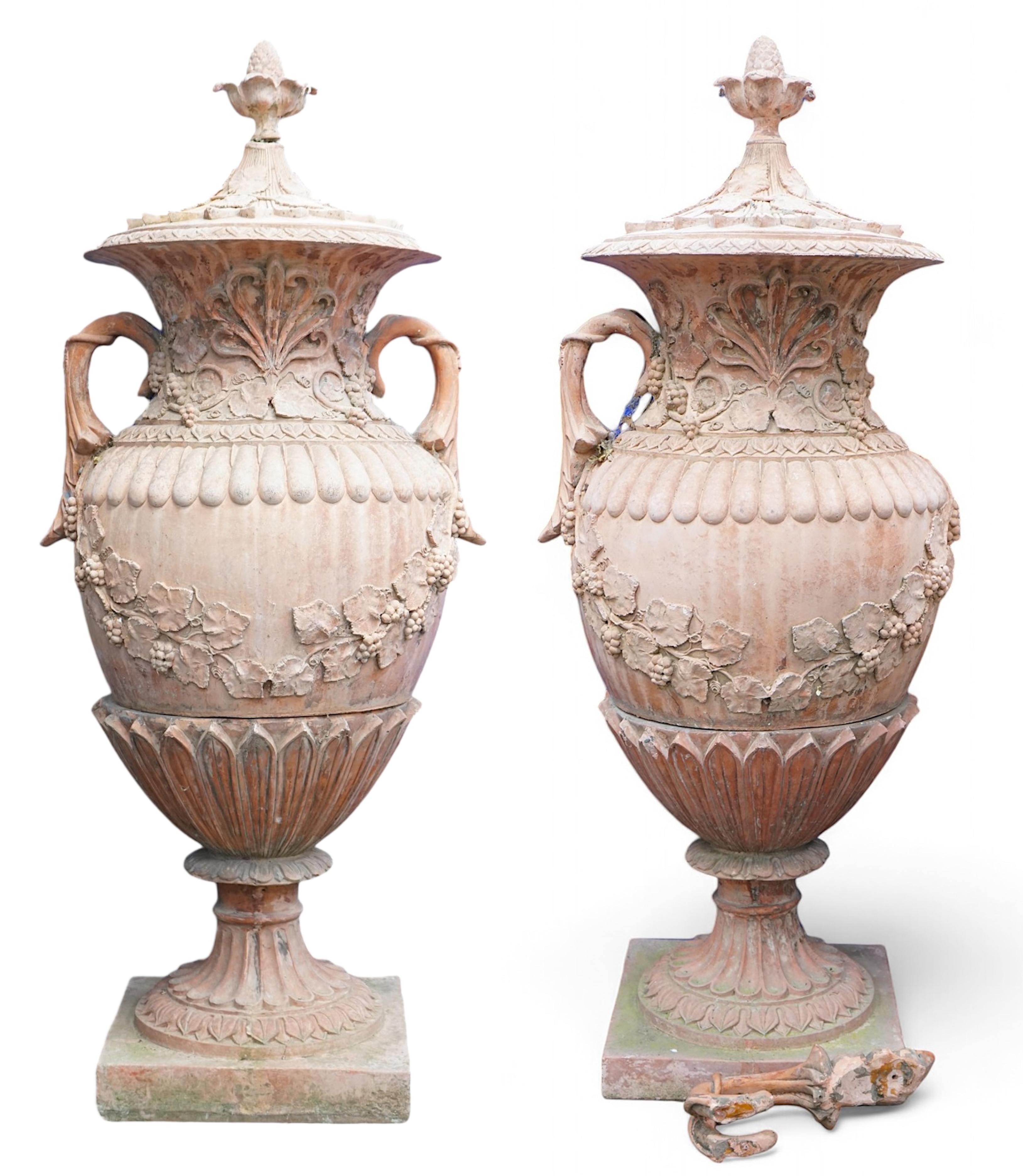 A pair of ornate terracotta urns and covers